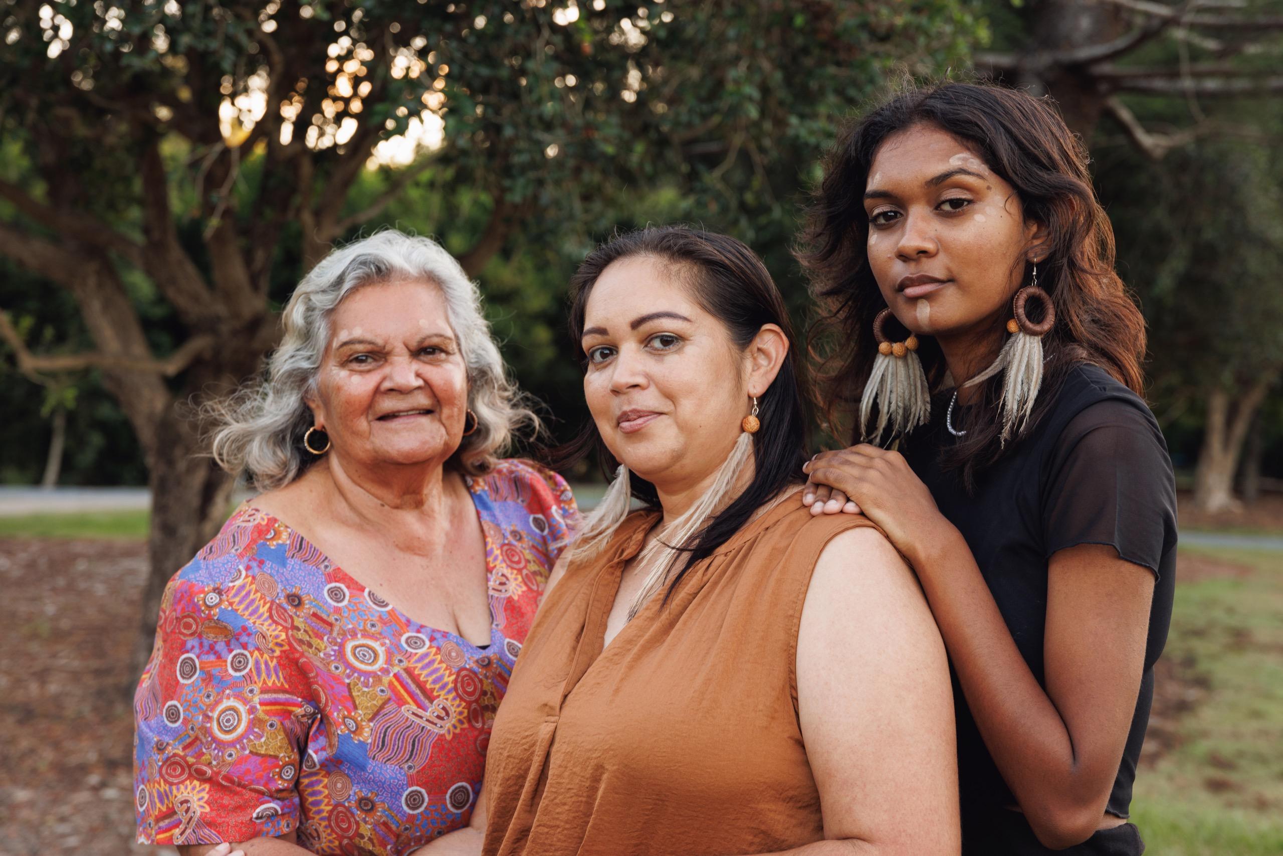 Three Aboriginal women from different generations, ideal for communicating cultural respect and community engagement within facilities operations.