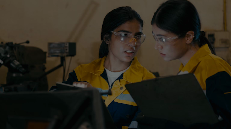 Lab technicians discussing results on a tablet